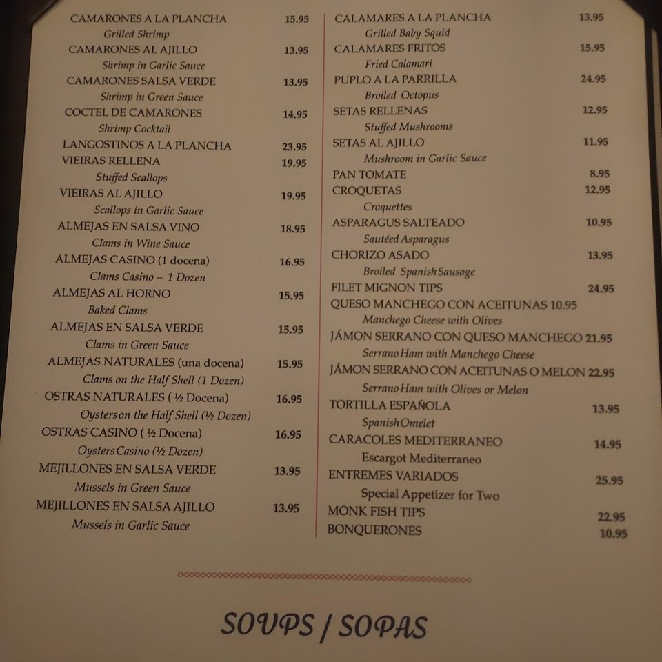 Menu page showing Spanish dishes and wine selections.